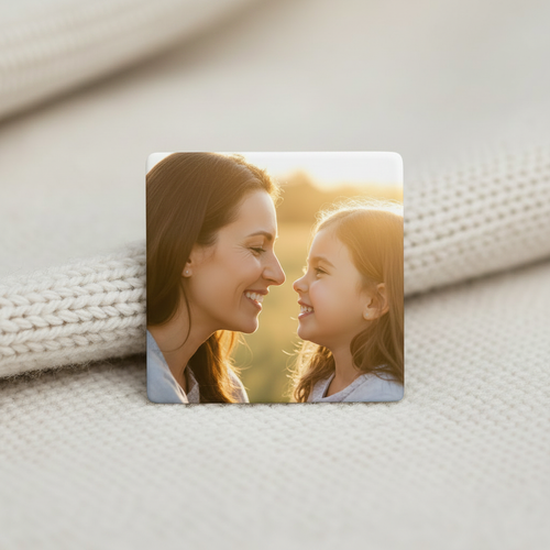 Close-up of a 2x2 personalized photo magnet with a full bleed print of a mother and daughter smiling outdoors